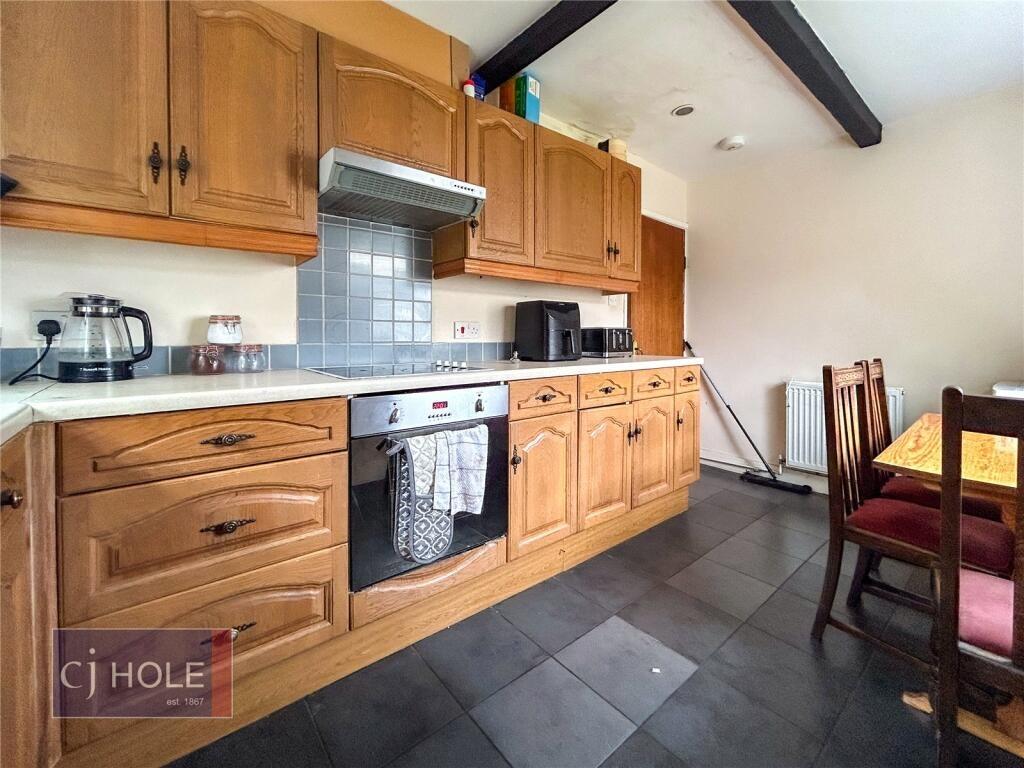 Bright and inviting kitchen space featuring woo...