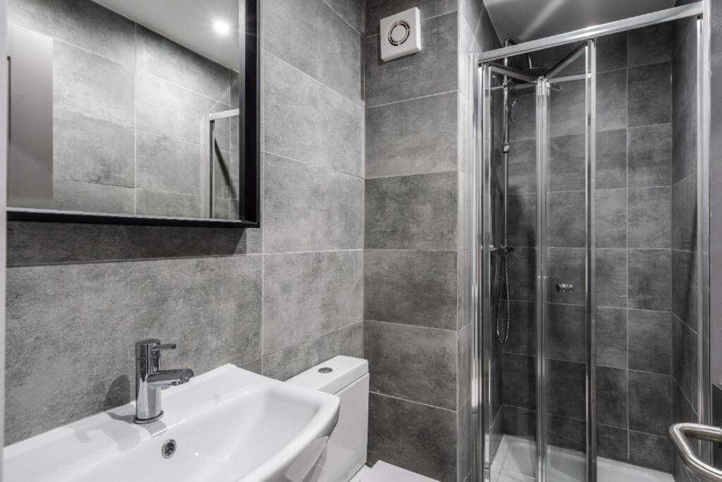 A modern and stylish bathroom featuring sleek t...