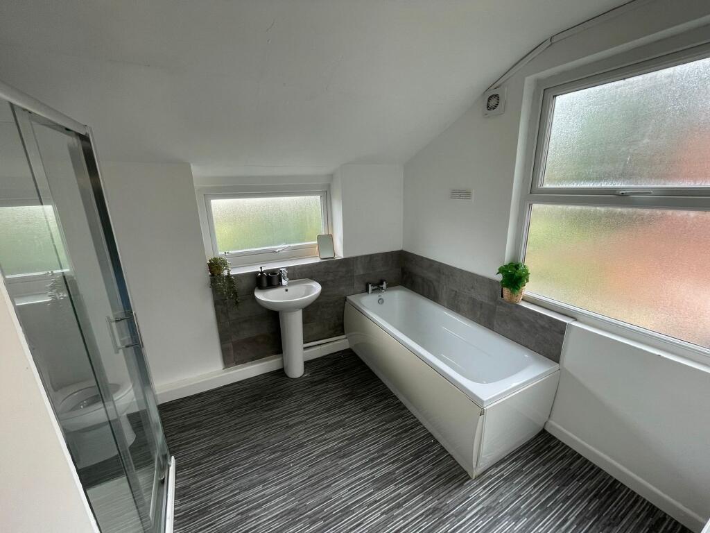 Bright and modern bathroom featuring a large ba...