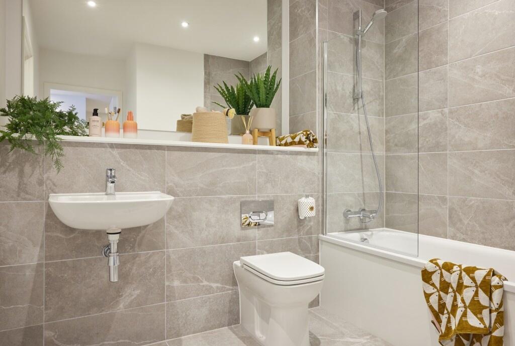 A modern, spacious bathroom suite featuring ele...