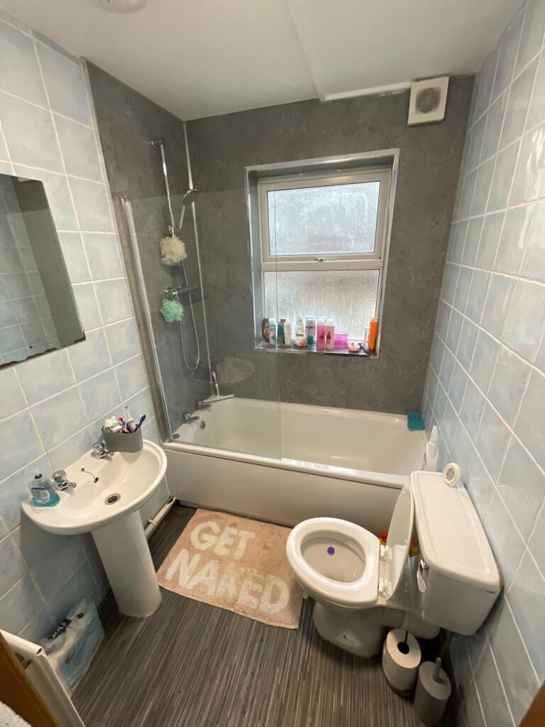 A bright and tidy bathroom featuring a full bat...