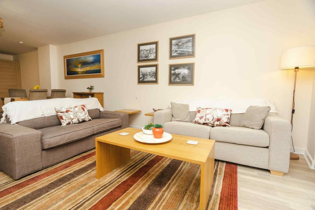 A welcoming living room featuring two comfortab...