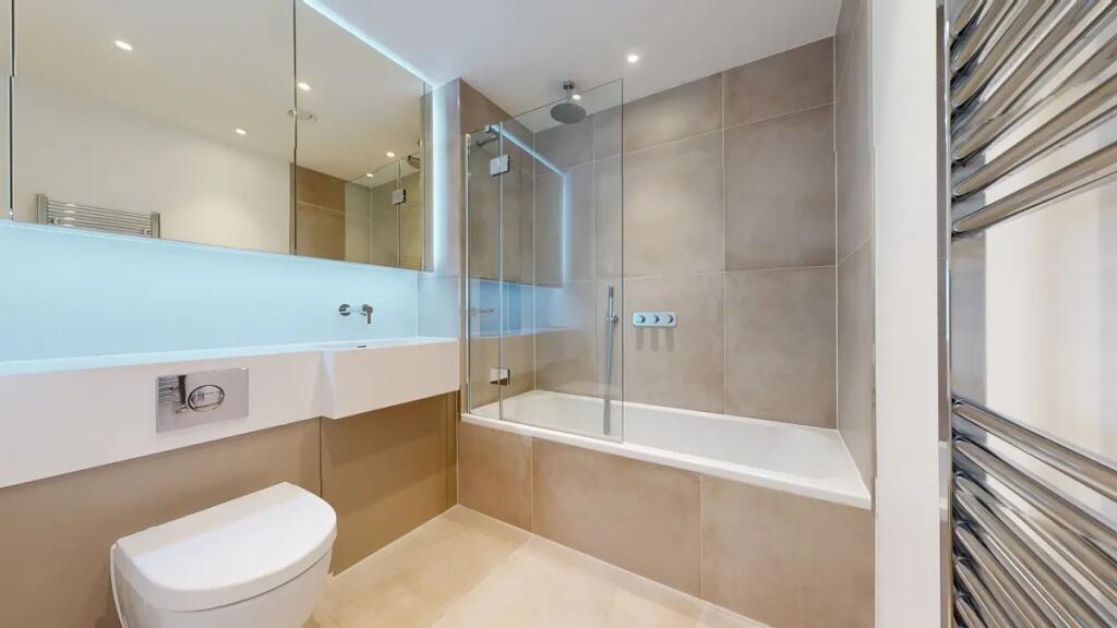 A sleek and modern bathroom suite featuring a f...