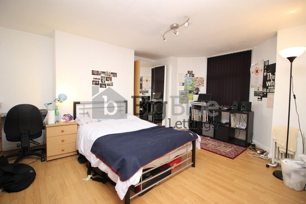A neat and welcoming double bedroom featuring a...