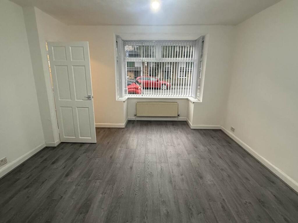 A bright and spacious living room with large wi...