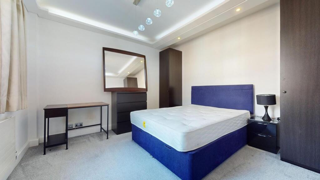 A modern double bedroom featuring a blue uphols...