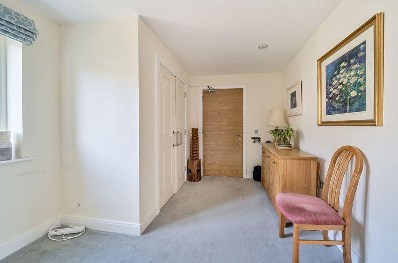 Spacious hallway with storage cupboard