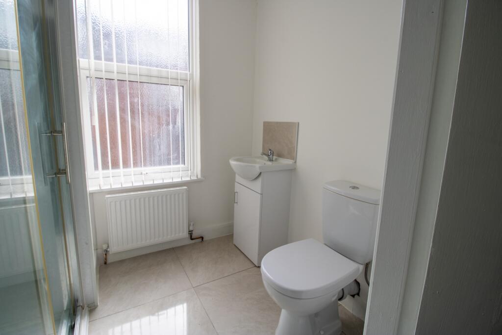 A bright and clean bathroom with a modern toile...