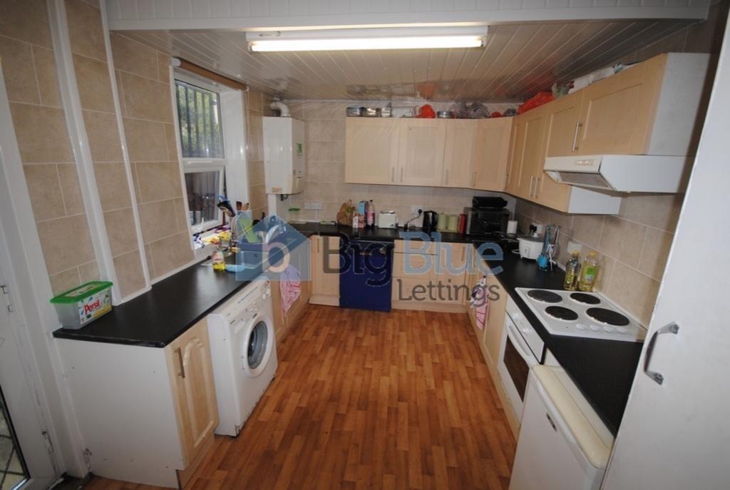 A well-equipped kitchen featuring ample cabinet...