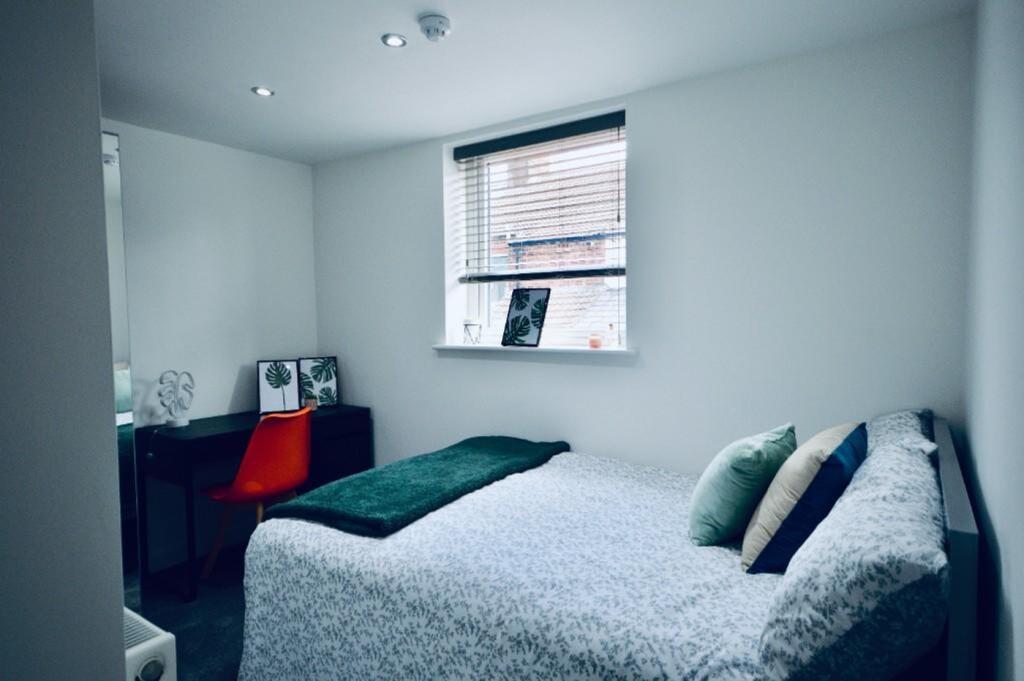 A bright and tidy double bedroom with modern de...
