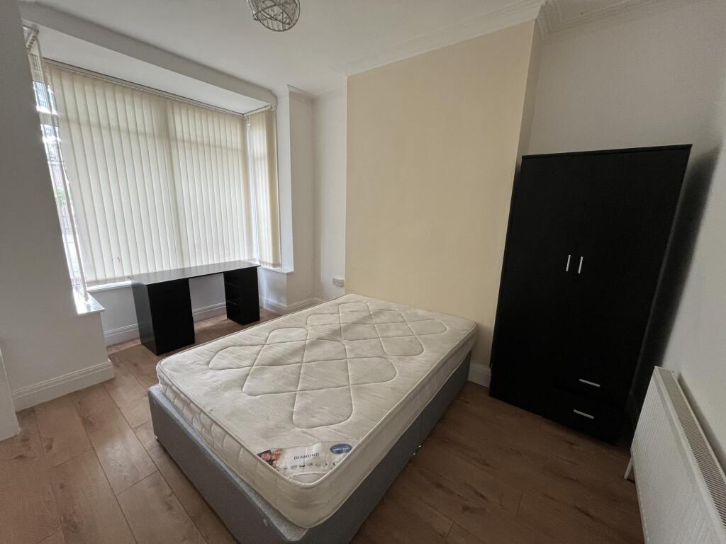 Bright and cozy single bedroom featuring a larg...