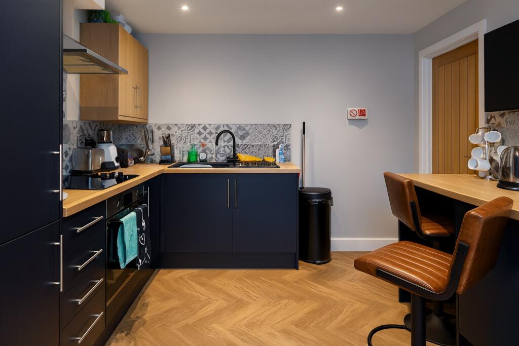 Modern and well-organized kitchen featuring sle...