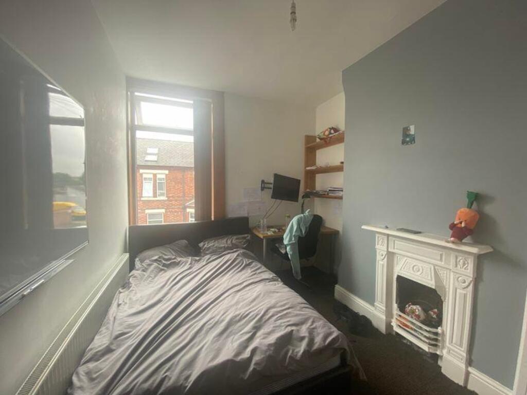 A cozy double bedroom with ample natural light ...