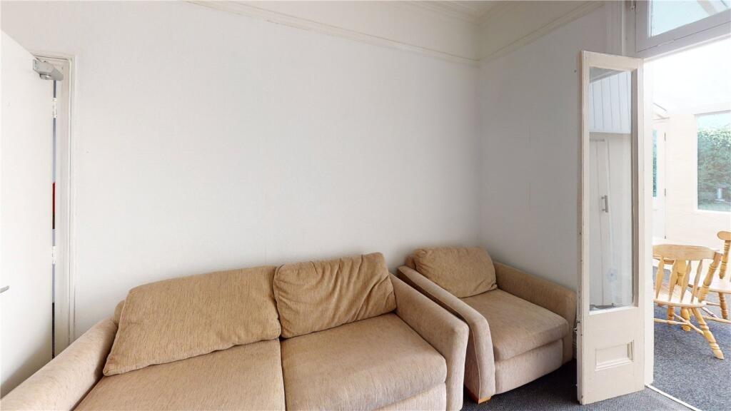 A cozy living room featuring a comfortable beig...
