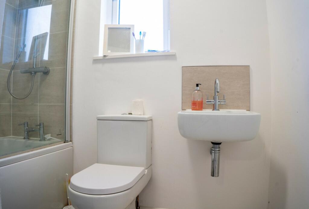 A clean and modern bathroom featuring a stylish...