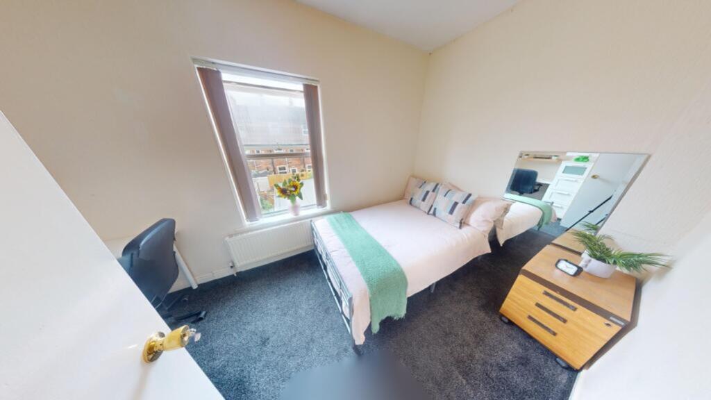 A cozy and inviting double bedroom with ample n...