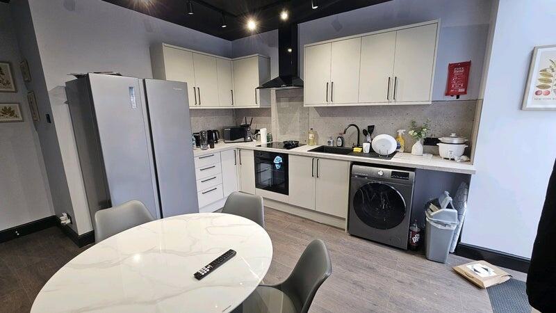 A modern, well-maintained kitchen with sleek wh...