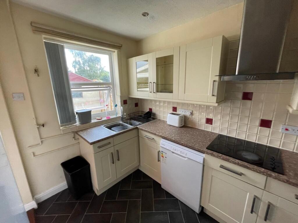 A well-equipped kitchen featuring modern cabine...
