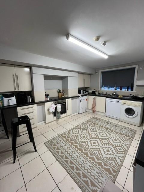 Bright, modern kitchen with plenty of cupboard ...