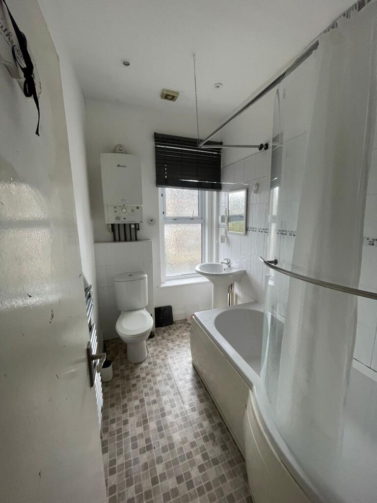 Bright and functional bathroom with a bathtub, ...