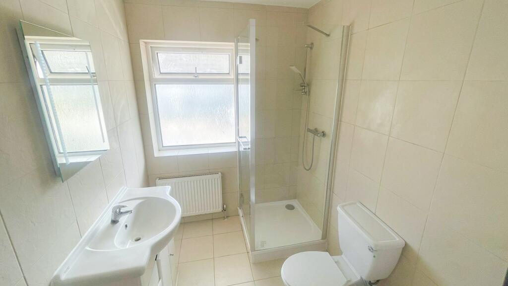 Bright and clean bathroom featuring a modern wa...