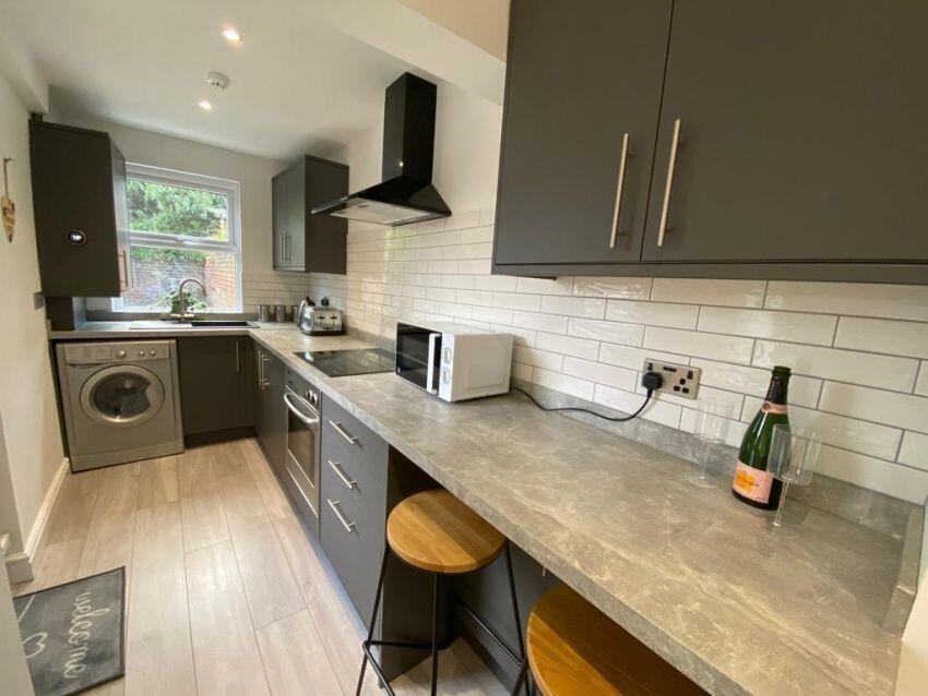 A modern kitchen featuring sleek grey cabinetry...