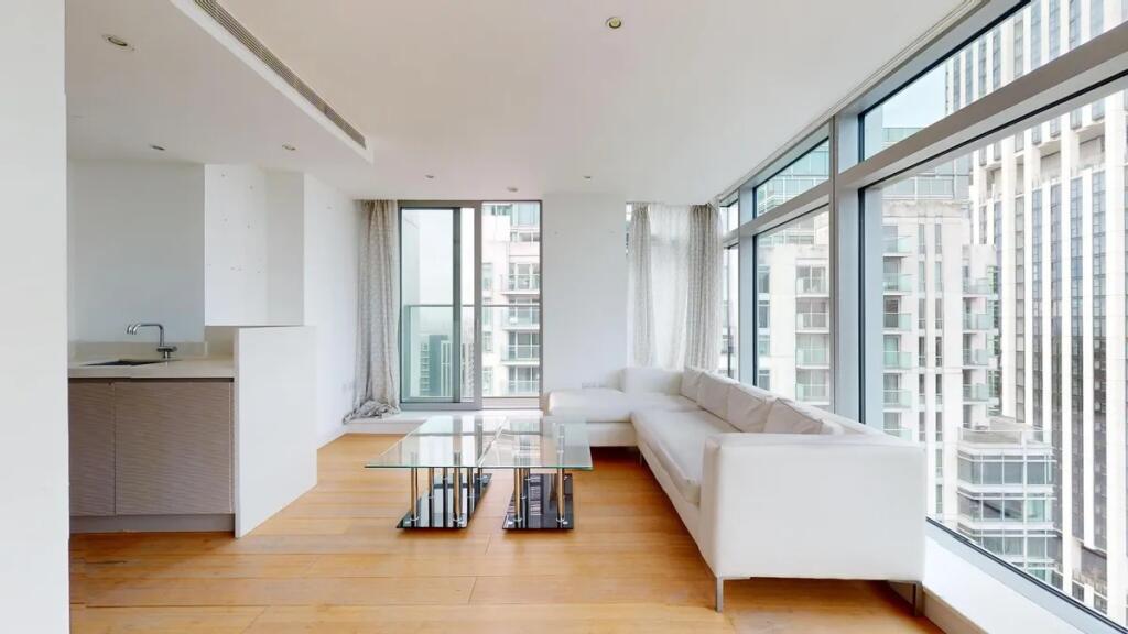 Bright and modern living room featuring floor-t...