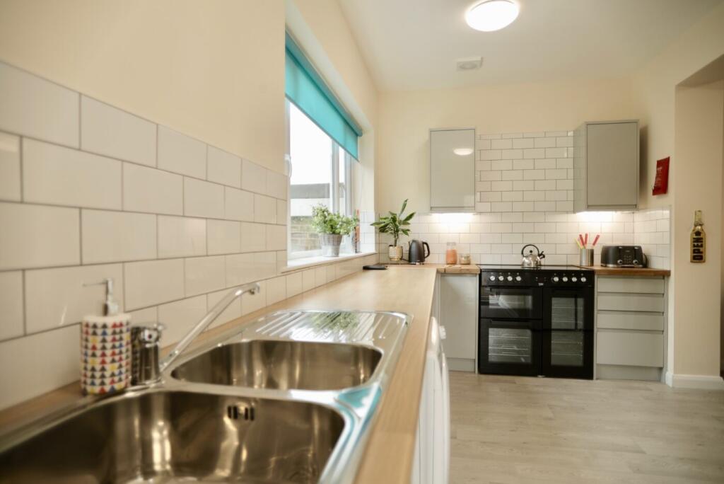 Bright and modern kitchen with a clean countert...