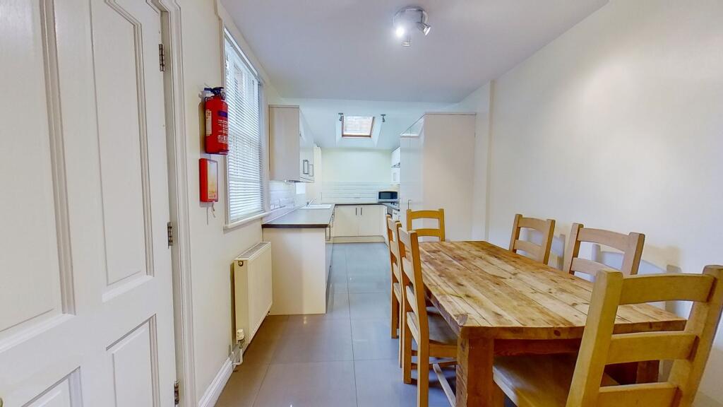Bright combined kitchen and dining area with a ...