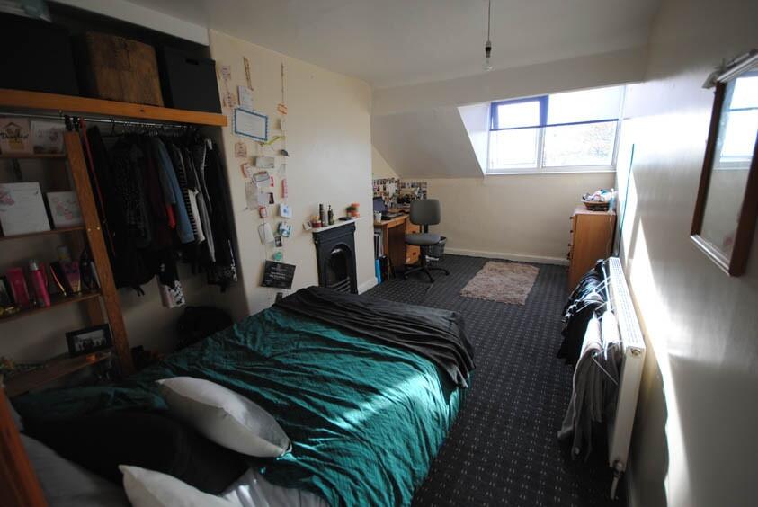 A cozy student bedroom featuring a double bed, ...