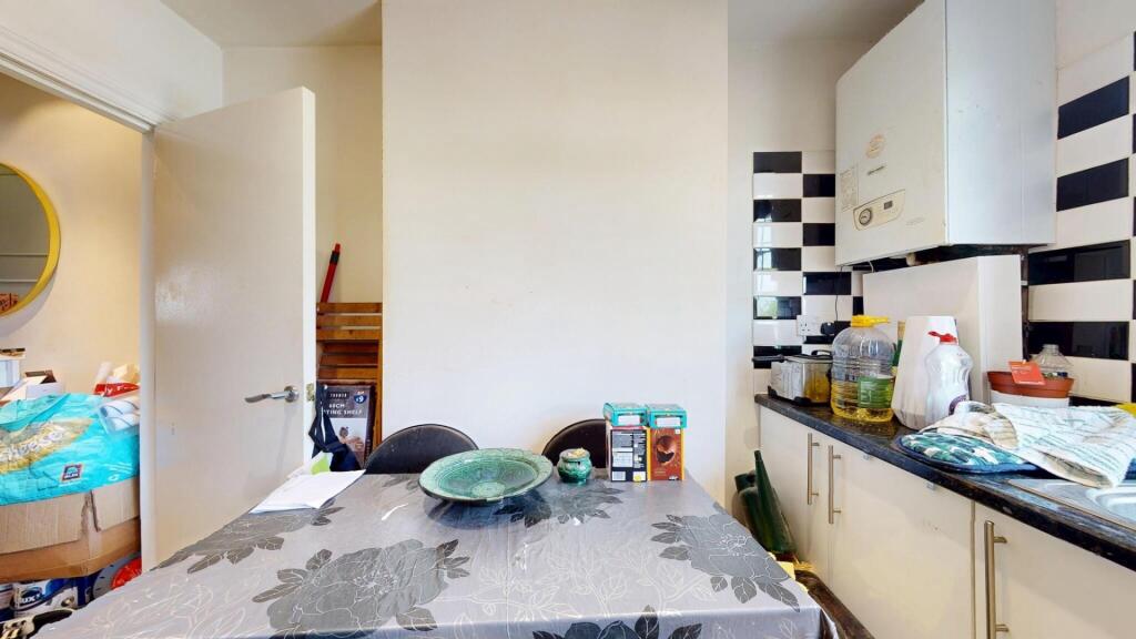 Bright kitchen area featuring contemporary blac...