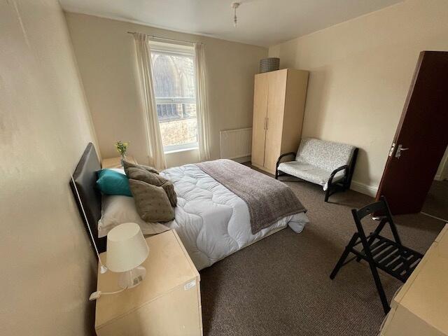 A bright and welcoming double bedroom featuring...