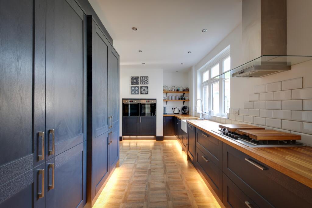 modern blue shaker kitchen with double oven