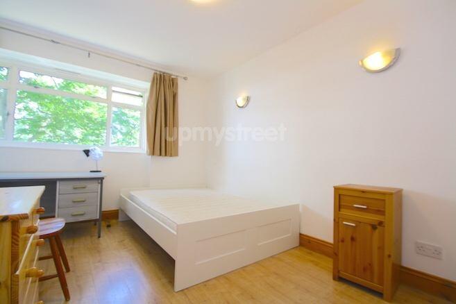 A bright and welcoming double bedroom with a la...