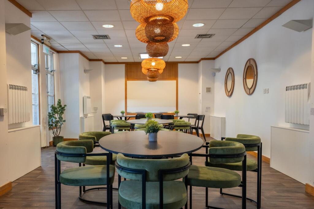 Bright and inviting communal workspace featurin...