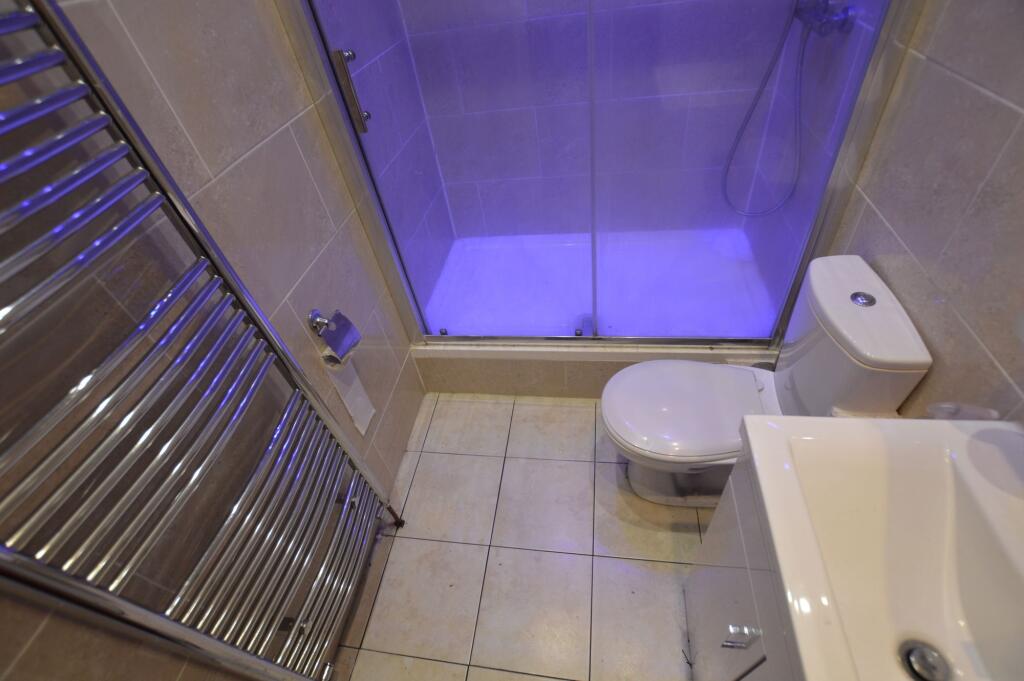 A modern bathroom featuring a sleek shower encl...