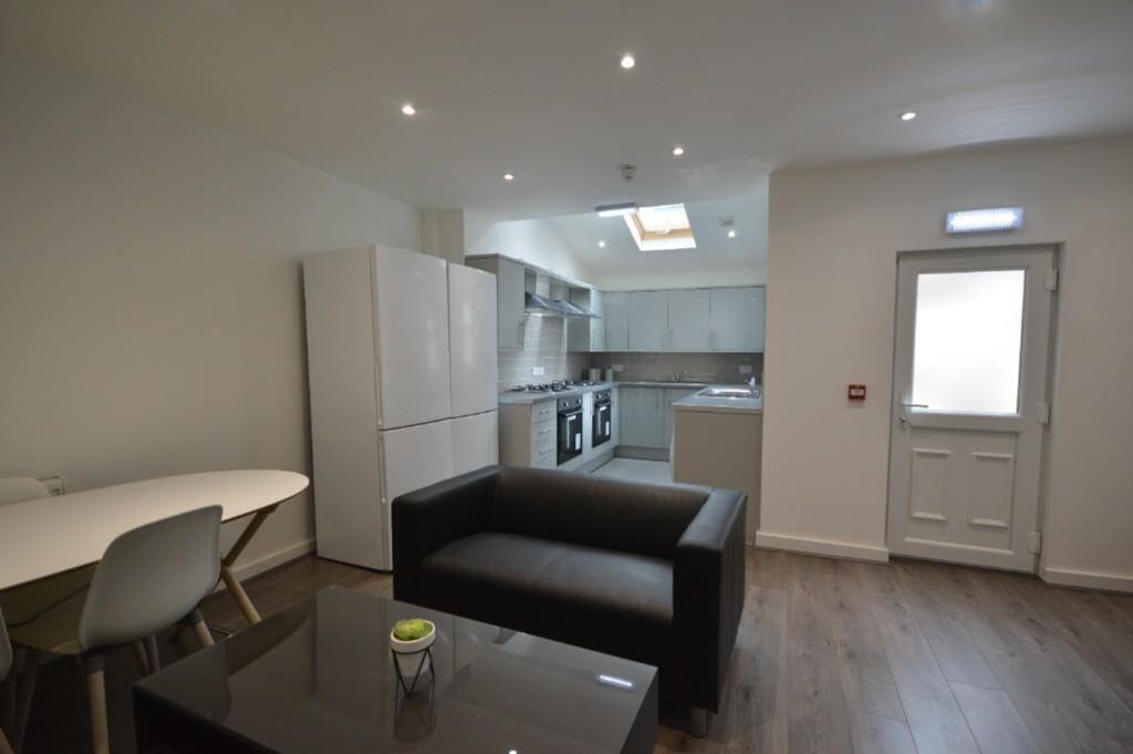 This modern kitchen features sleek cabinetry, a...
