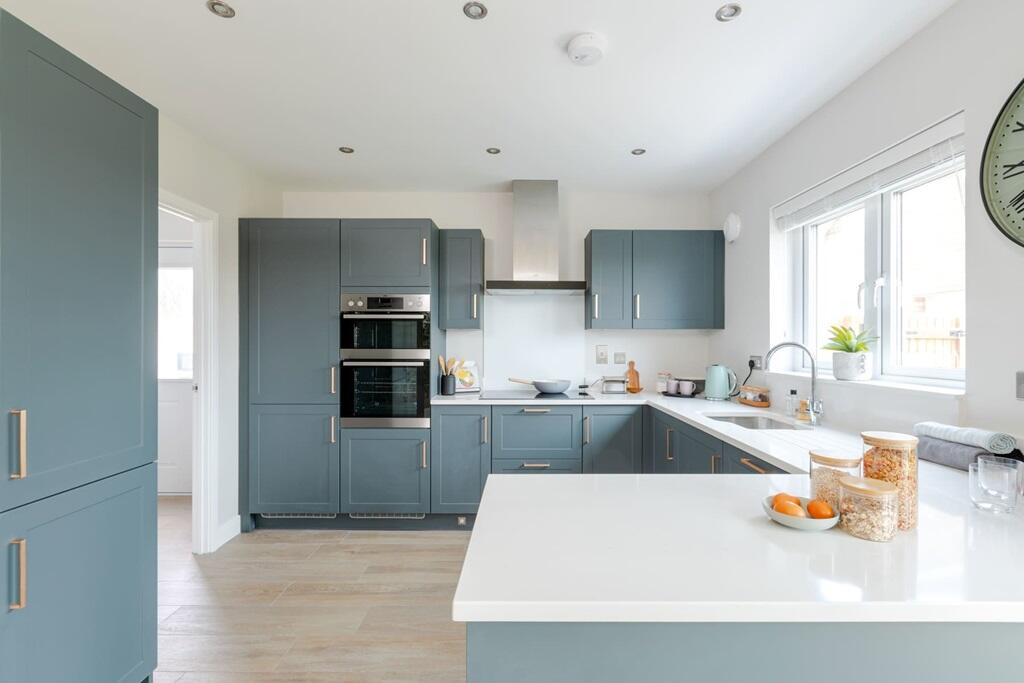 The modern kitchen has ample storage and worktop space