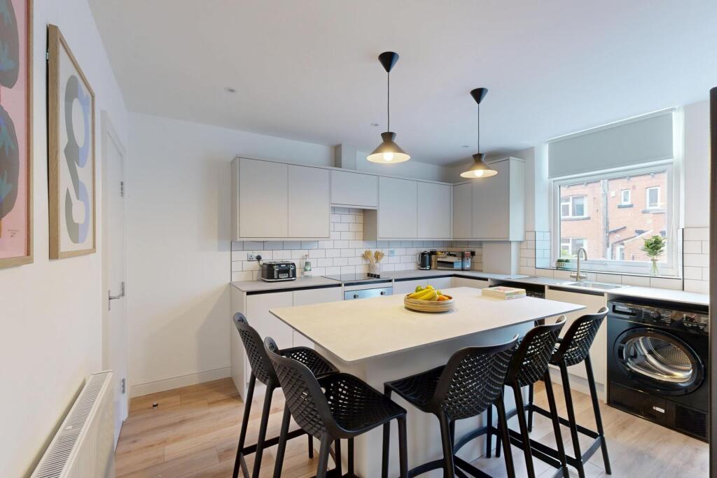 Modern and bright kitchen area with ample natur...