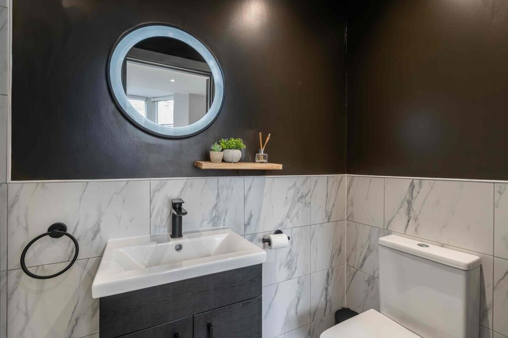 Modern bathroom featuring a sleek white sink, a...