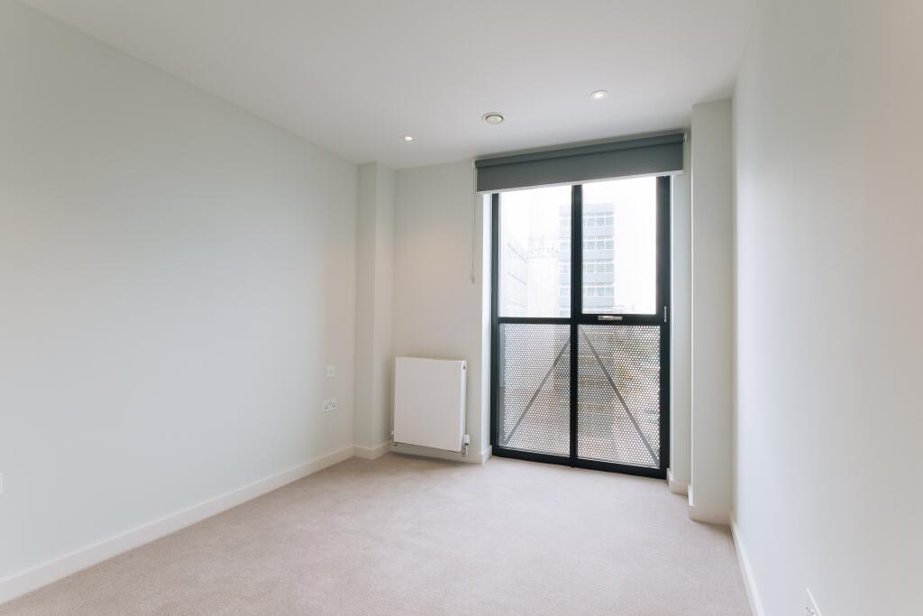 Experience modern simplicity with abundant natural light in this chic urban apartment.