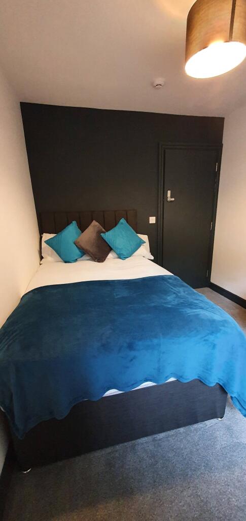 Cozy double bedroom featuring a comfortable bed...