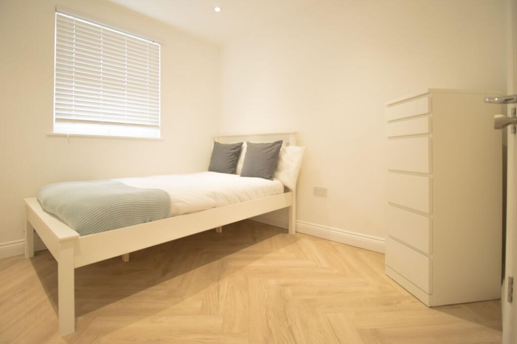 A bright and inviting double bedroom featuring ...