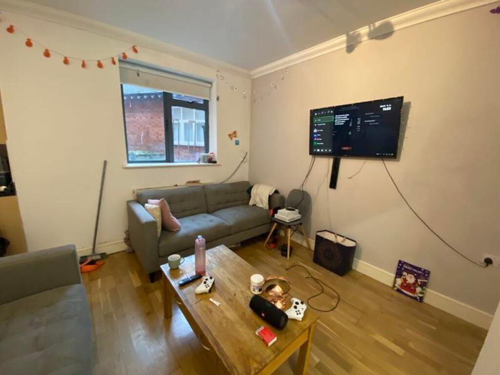 A cozy living room featuring a comfortable sofa...