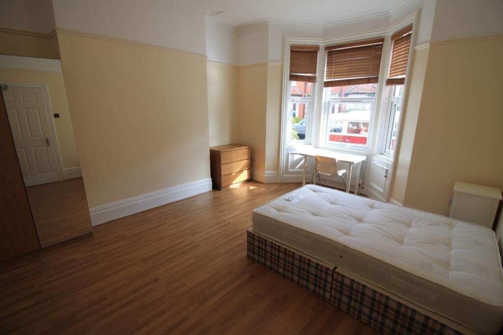Bright and spacious double bedroom featuring la...