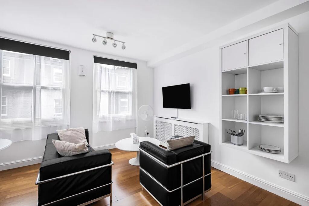 Bright and modern living room featuring sleek b...