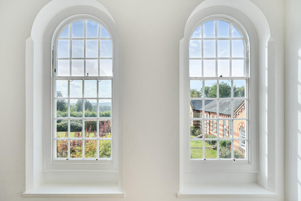 Operational sash windows with views over the communal grounds and The South Downs