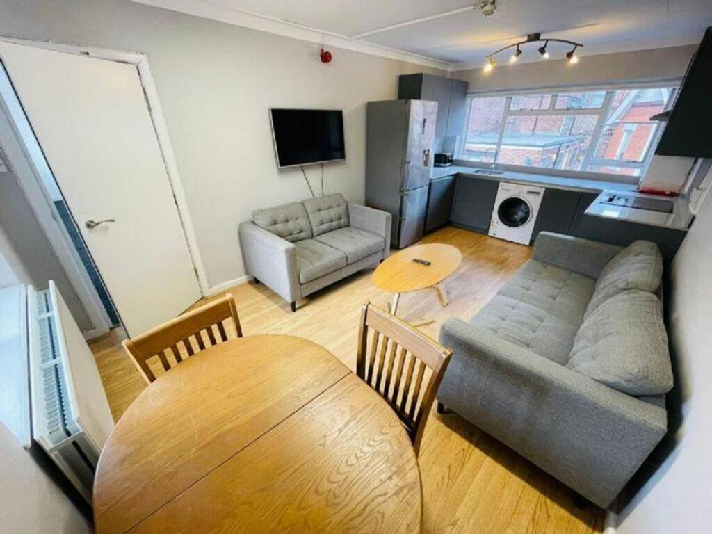 A spacious and contemporary living room featuri...