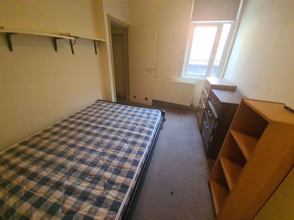 A cozy single bedroom featuring a comfortable b...