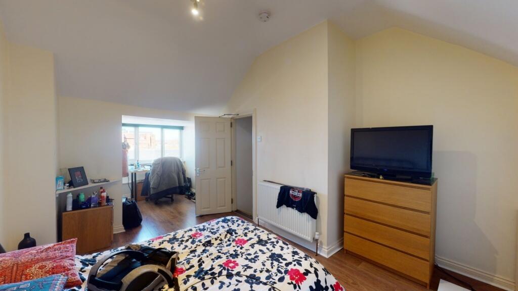 Bright and spacious master bedroom featuring a ...